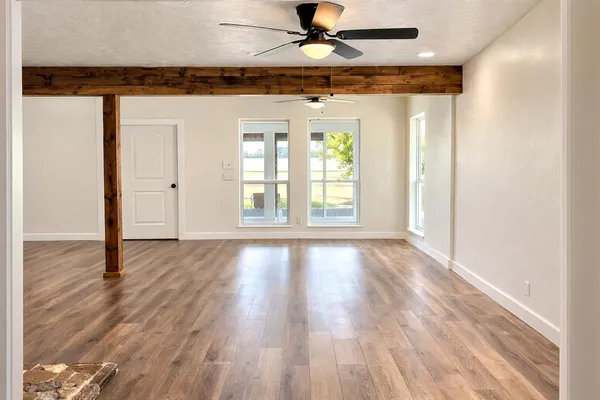 wooden floor in an empty room with a window