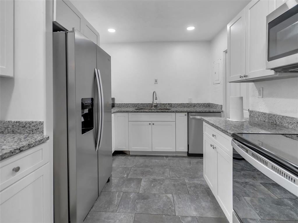 2600 Euston Road Winter Park, FL 32789 - Photo 3 of 36 a kitchen with stainless steel appliances granite countertop a stove a sink and a refrigerator