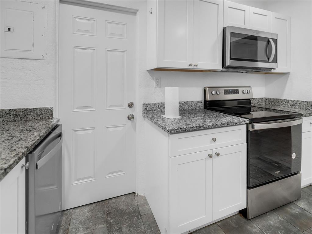 2600 Euston Road Winter Park, FL 32789 - Photo 4 of 36 a kitchen with stainless steel appliances granite countertop white cabinets and stove