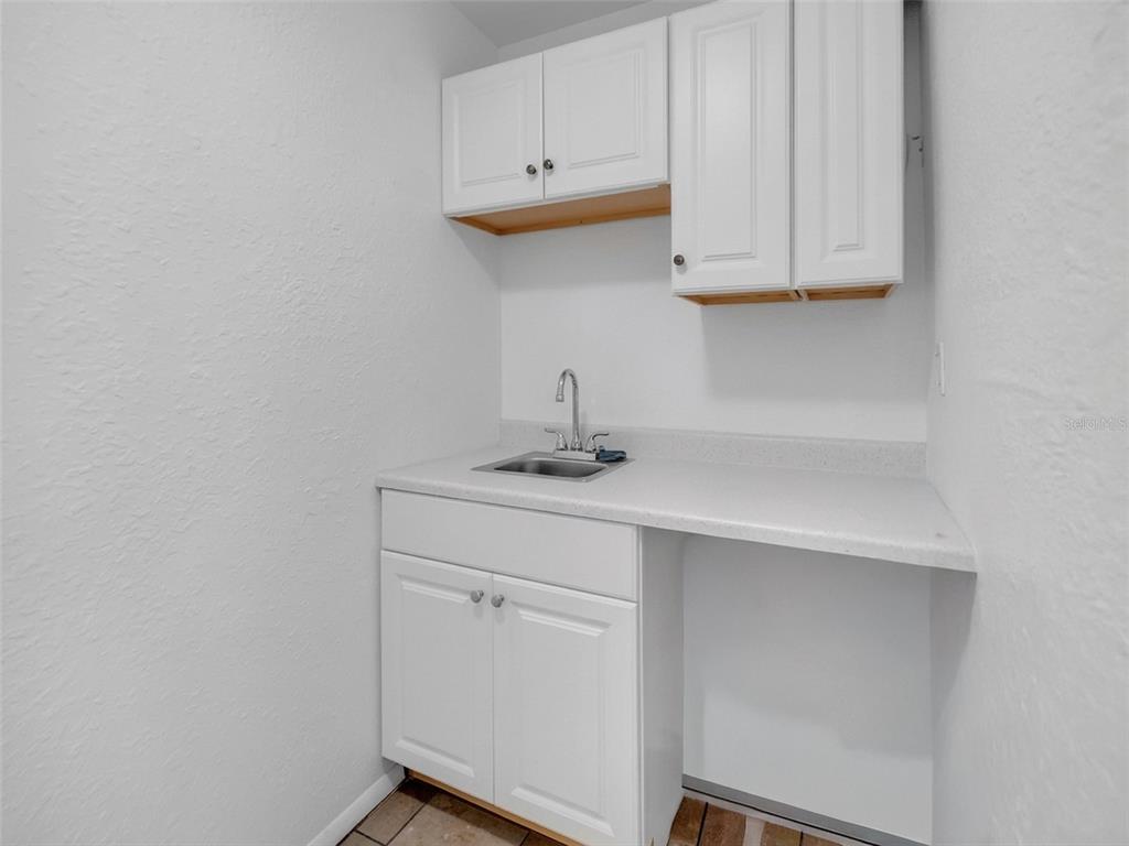 2600 Euston Road Winter Park, FL 32789 - Photo 9 of 36 a kitchen with white cabinets and a sink