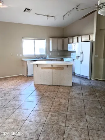 a kitchen with a sink a counter space and appliances