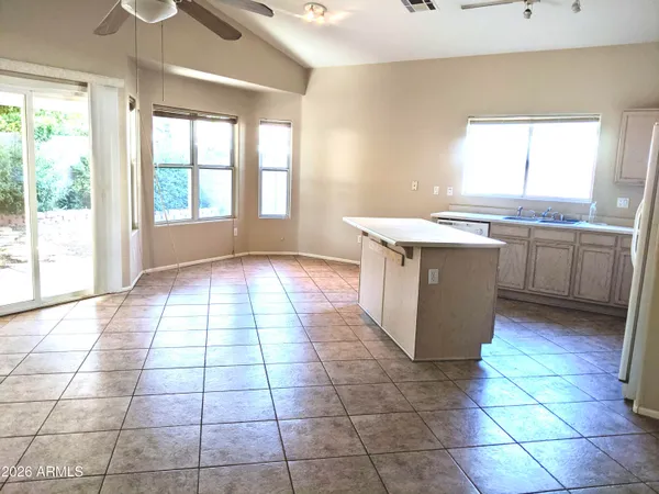 a kitchen with a sink a stove top oven and cabinets