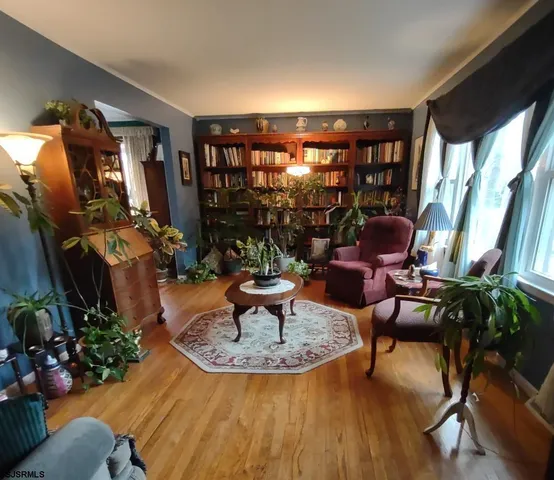 a living room with furniture and a floor to ceiling window