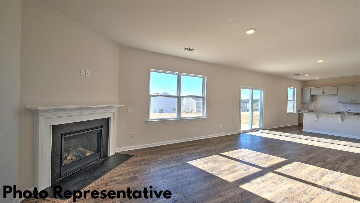 234 Wheatfield Road Fletcher, NC 28732 - Photo 11 of 27 a view of an empty room with a fireplace and a window