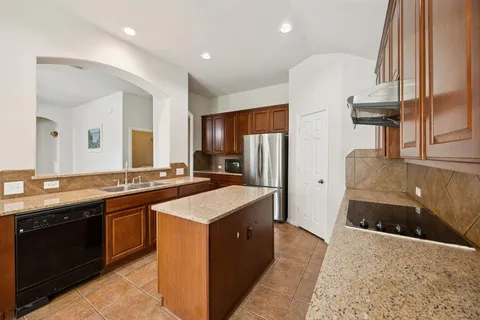 a kitchen with stainless steel appliances a sink stove and refrigerator