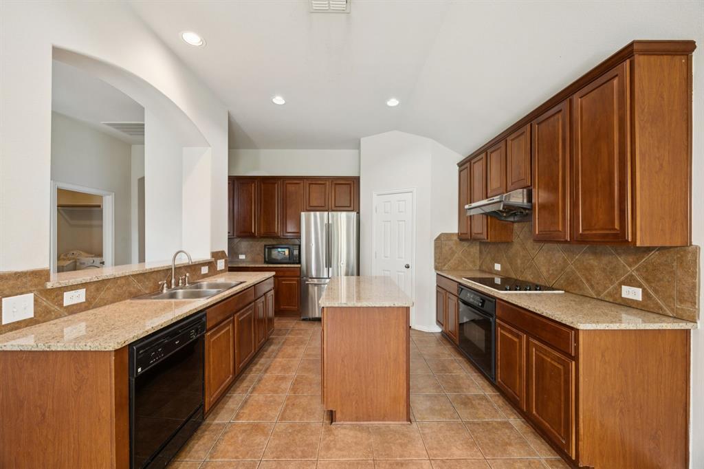 3501 Gravel Circle North Grapevine, TX 76092 - Photo 14 of 36 a large kitchen with stainless steel appliances granite countertop a stove a sink dishwasher and a refrigerator