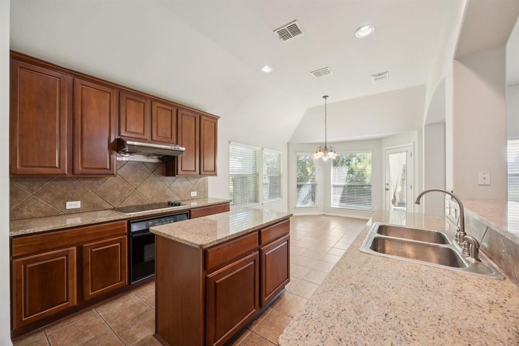 3501 Gravel Circle North Grapevine, TX 76092 - Photo 15 of 36 a kitchen with a stove sink and cabinets