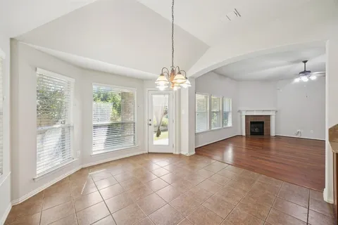 a view of an empty room with window and cabinet
