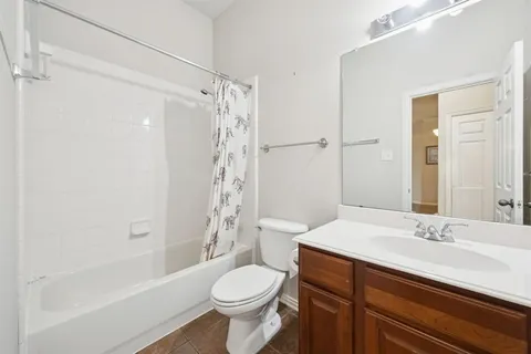 a bathroom with a sink toilet a mirror and shower