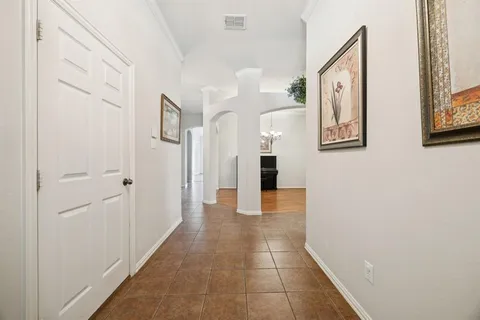 a view of a hallway with paintings on the wall