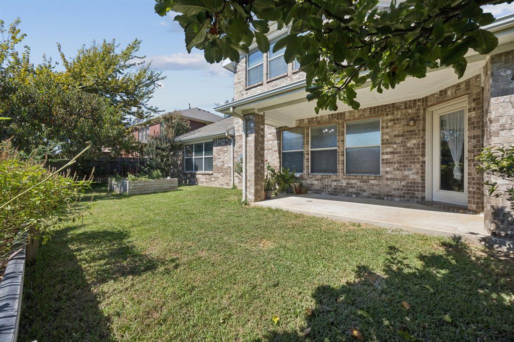 3501 Gravel Circle North Grapevine, TX 76092 - Photo 35 of 36 a view of a yard in front of a brick house with plants and large trees