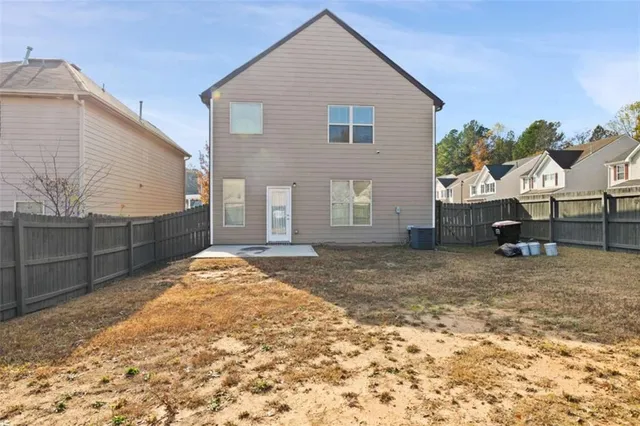 a view of a house with a backyard