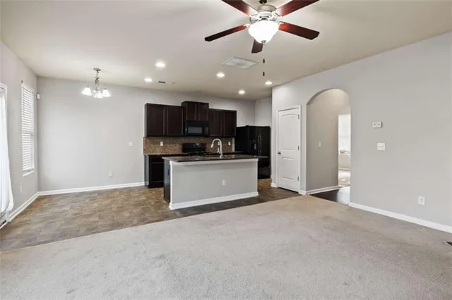 a view of a kitchen with a microwave and a ceiling fan