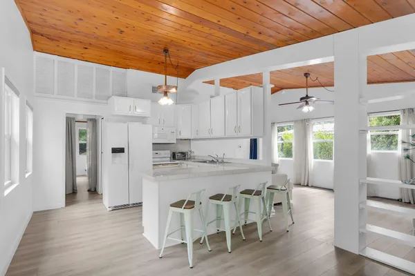 a kitchen with stainless steel appliances granite countertop a sink and refrigerator
