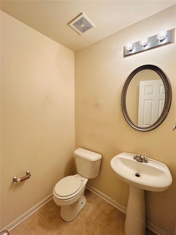 2920 Centerglen Lane Cumming, GA 30040 - Photo 6 of 14 a bathroom with a sink a toilet and a mirror
