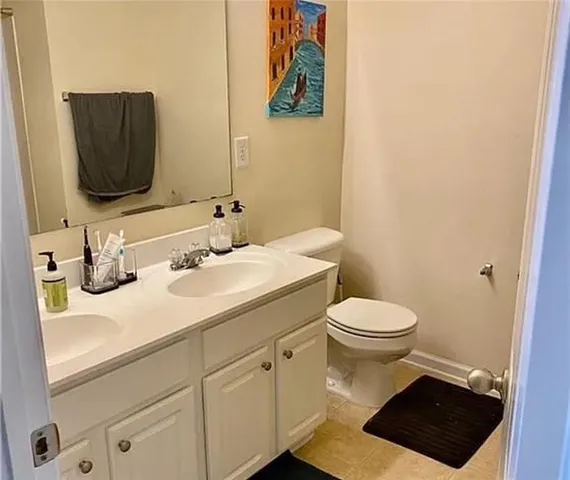 a bathroom with a toilet a sink and mirror