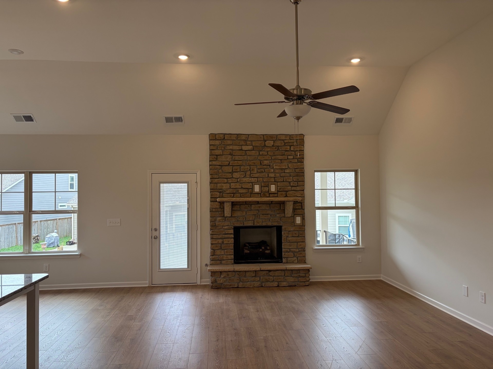 7006 Sully Court Fairview, TN 37062 - Photo 2 of 9 a view of an empty room with wooden floor fireplace and a window