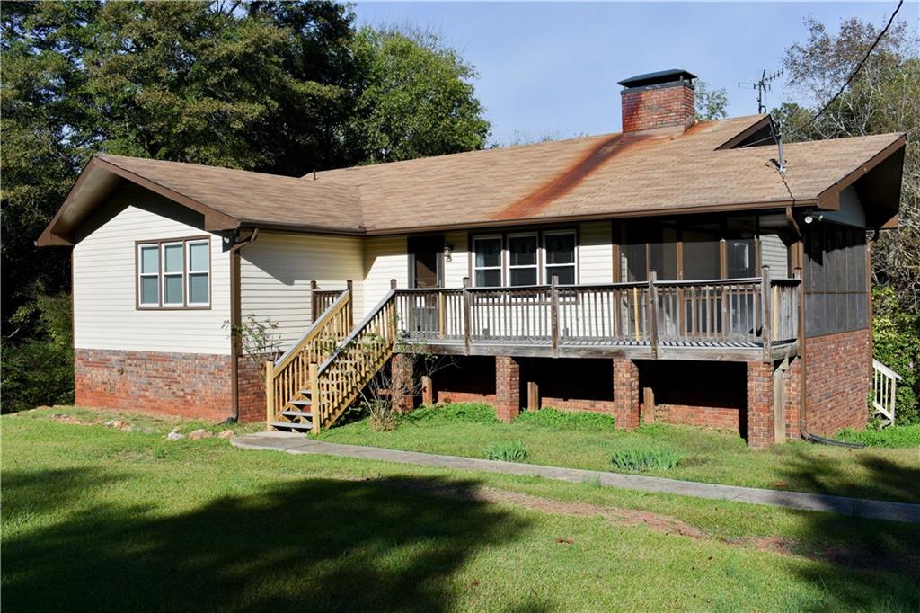 6882 Cowan Mill Road Winston, GA 30187 - Photo 1 of 50 a view of a house with a yard and sitting area