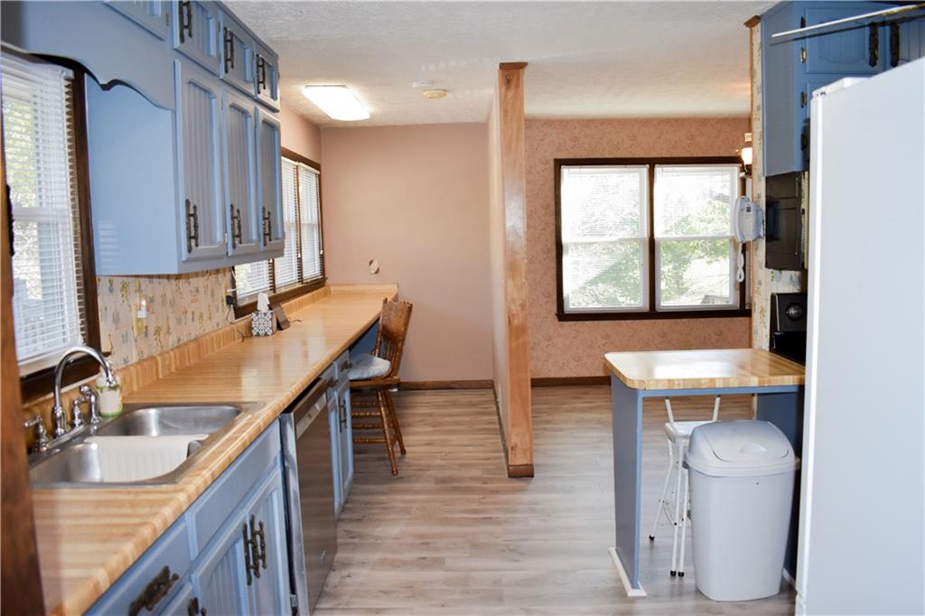 6882 Cowan Mill Road Winston, GA 30187 - Photo 16 of 50 a kitchen with a sink stove and cabinets