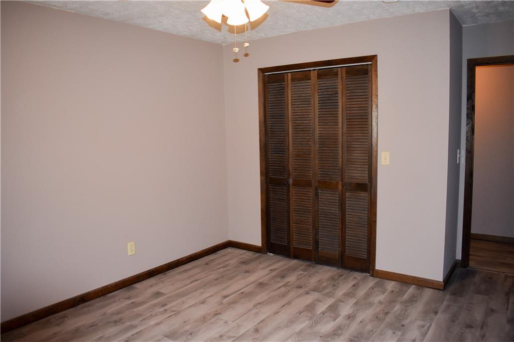 6882 Cowan Mill Road Winston, GA 30187 - Photo 17 of 50 an empty room with wooden floor and door