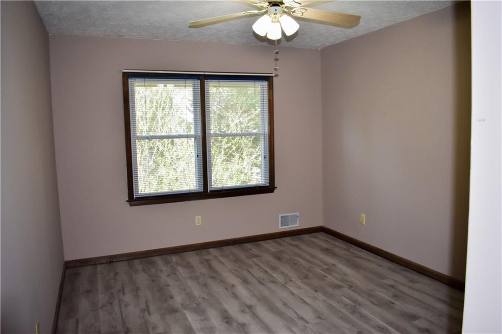 6882 Cowan Mill Road Winston, GA 30187 - Photo 18 of 50 an empty room with wooden floor and windows