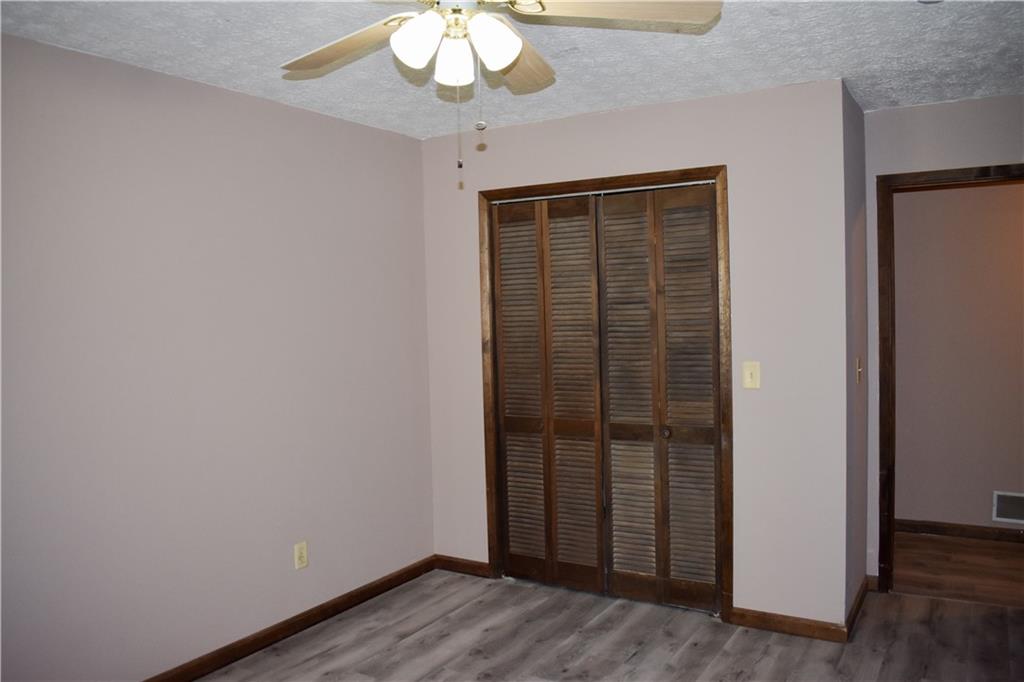 6882 Cowan Mill Road Winston, GA 30187 - Photo 19 of 50 an empty room with wooden floor cabinet and windows