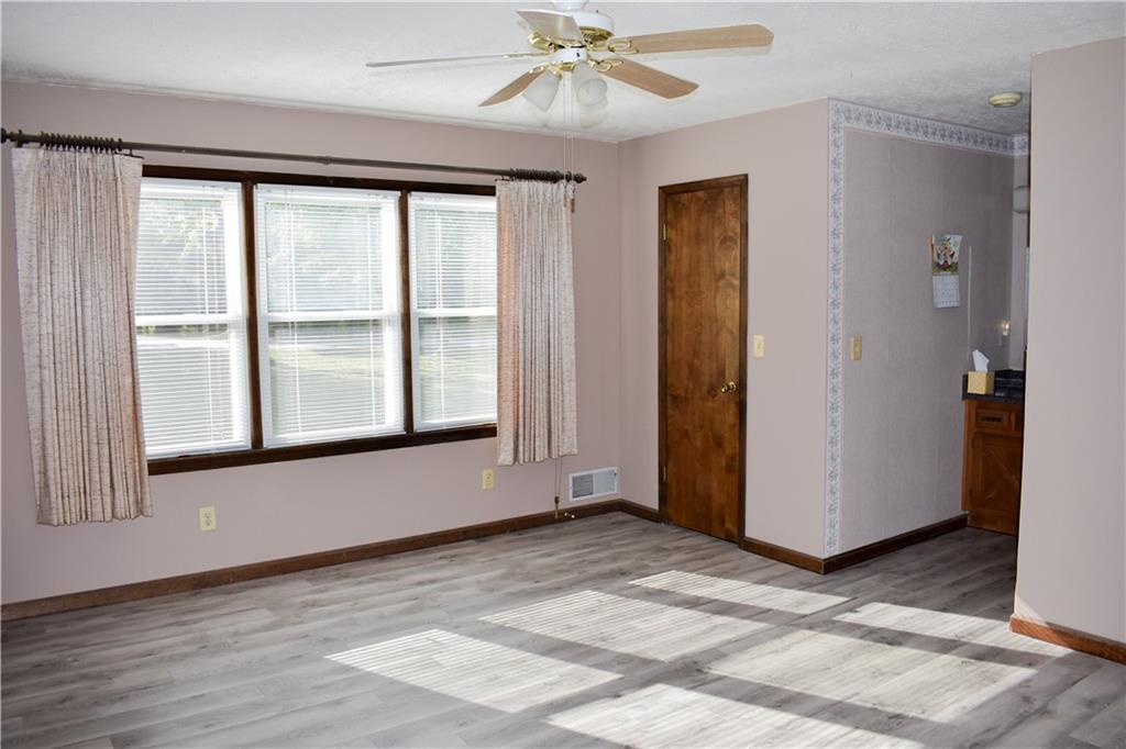 6882 Cowan Mill Road Winston, GA 30187 - Photo 23 of 50 a view of an empty room with a window and wooden floor
