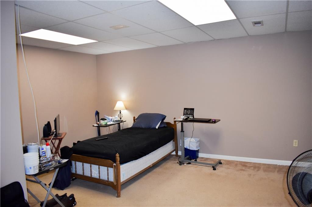 6882 Cowan Mill Road Winston, GA 30187 - Photo 29 of 50 a bedroom with a bed and a table