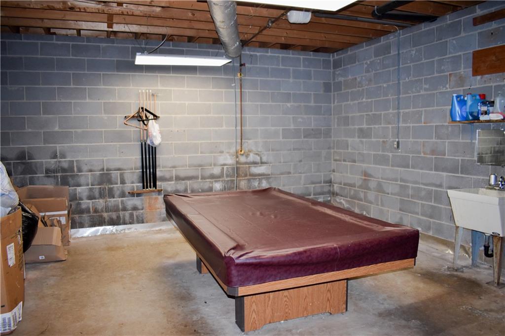 6882 Cowan Mill Road Winston, GA 30187 - Photo 38 of 50 a bath tub sitting next to a blue sink