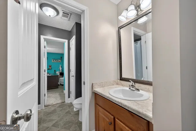 a en suite bathroom with a sink and a mirror