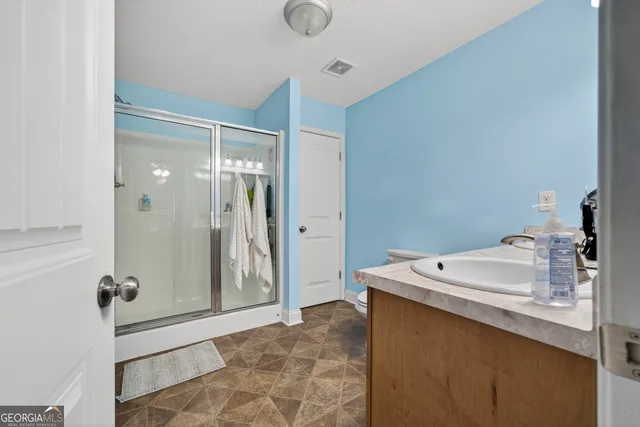 a bathroom with a double vanity sink and a mirror