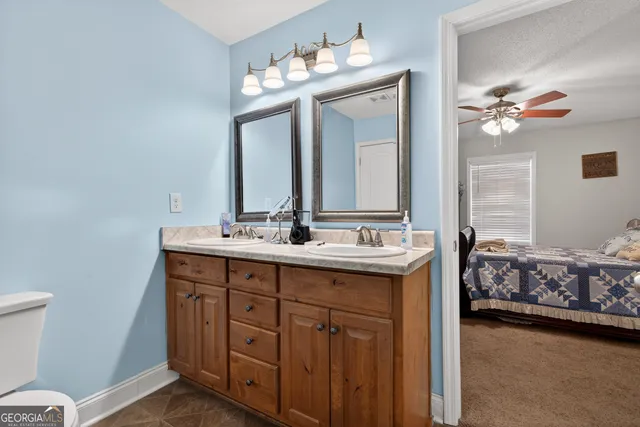 a bathroom with a toilet sink and mirror