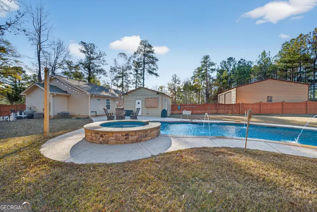 a view of a house with swimming pool and sitting area