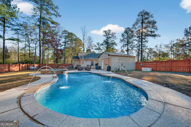 swimming pool view with outdoor seating