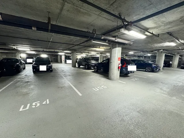 a view of parking garage with cars