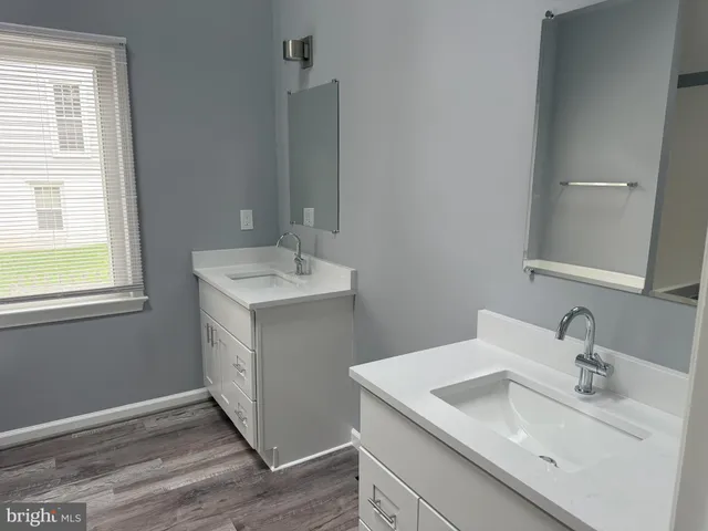 a bath tub sitting in a bathroom next to a window