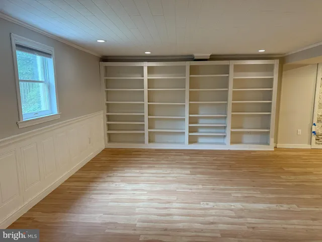 a living room with furniture and a book shelf