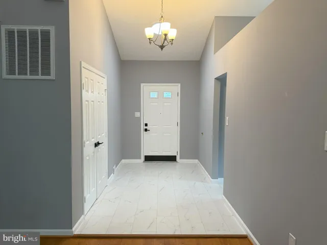 a view of a chandelier fan and wooden floor
