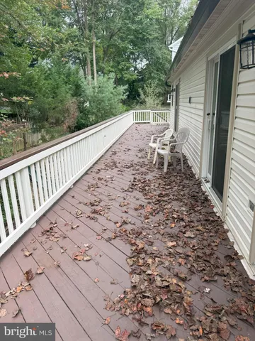 a view of a small house with wooden fence