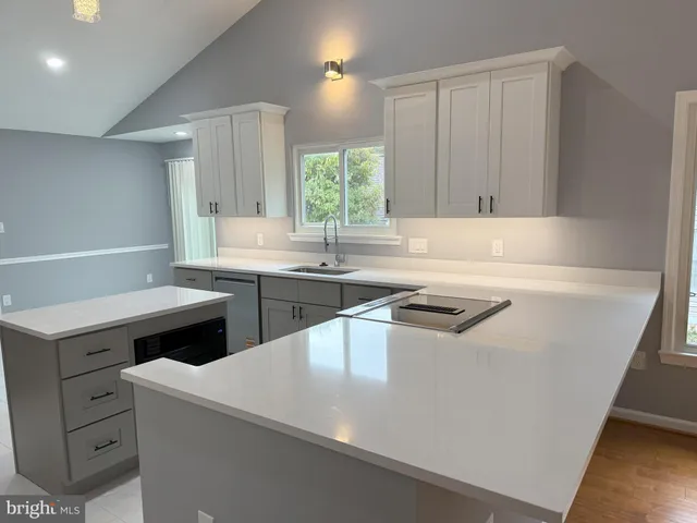 a kitchen with a sink a stove and cabinets