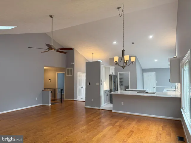a view of large kitchen with a refrigerator a sink and a stove