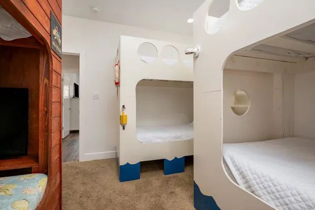 a bedroom with a bed and a mirror