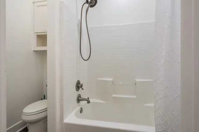 a bathroom with a shower and a toilet