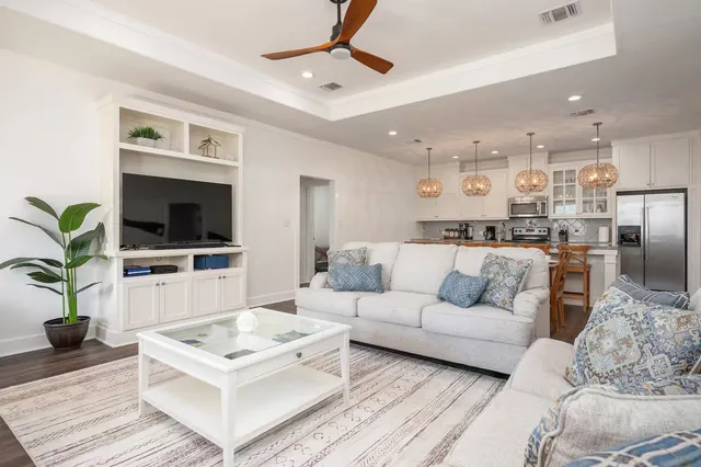 a living room with furniture a flat screen tv and a dining table