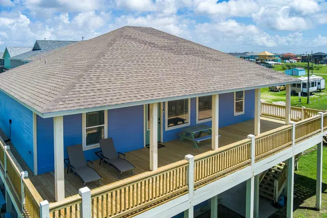 a view of a house with wooden deck