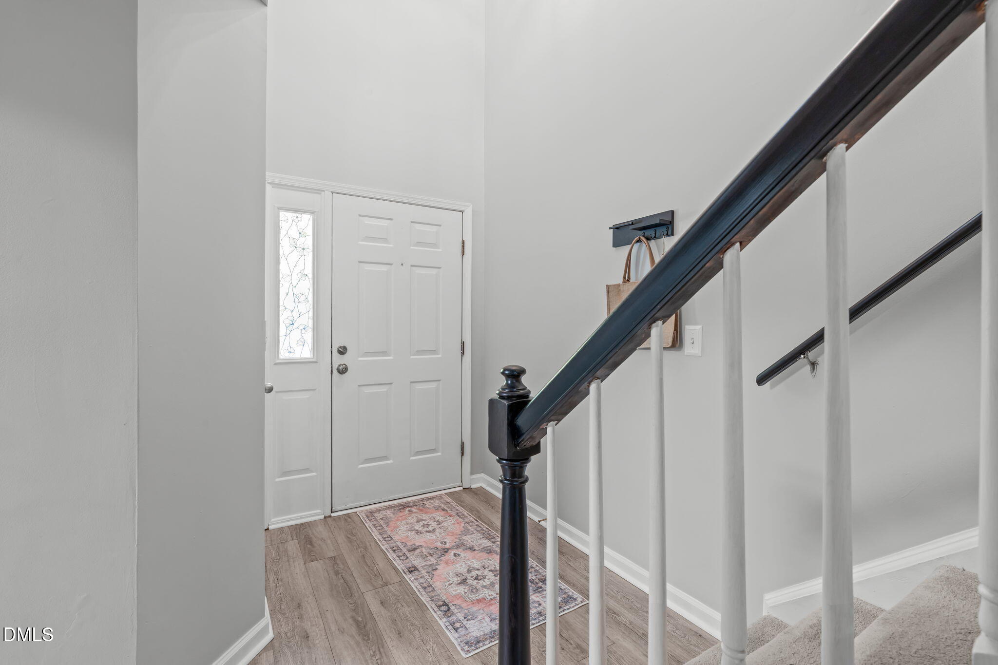 203 Oak Hollow Court Raleigh, NC 27613 - Photo 2 of 37 a view of staircase with wooden floor and white walls