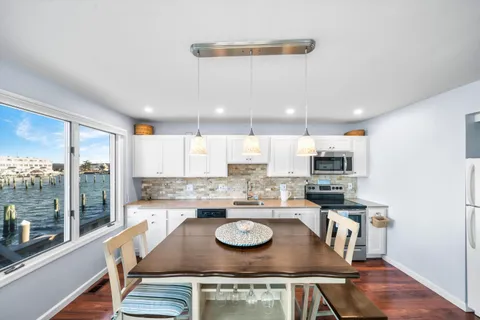 a kitchen with a stove a sink and a refrigerator