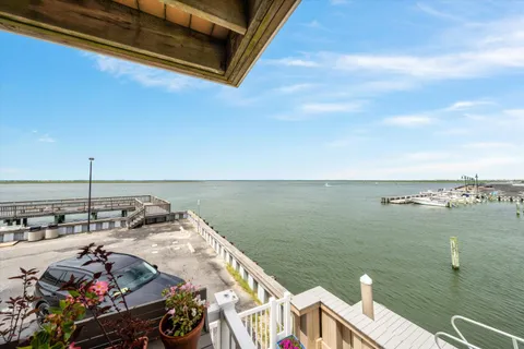 a view of roof deck with two chairs and a table