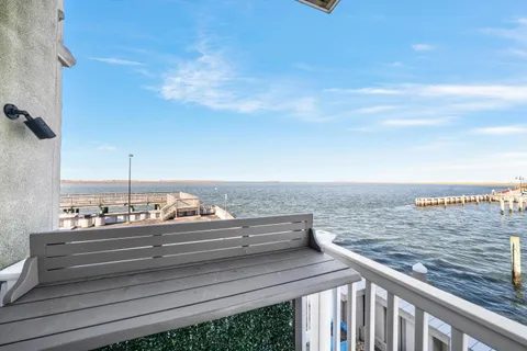 a view of washer and dryer with bathroom in the background