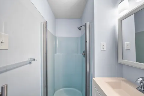 a bathroom with a sink toilet and shower curtain